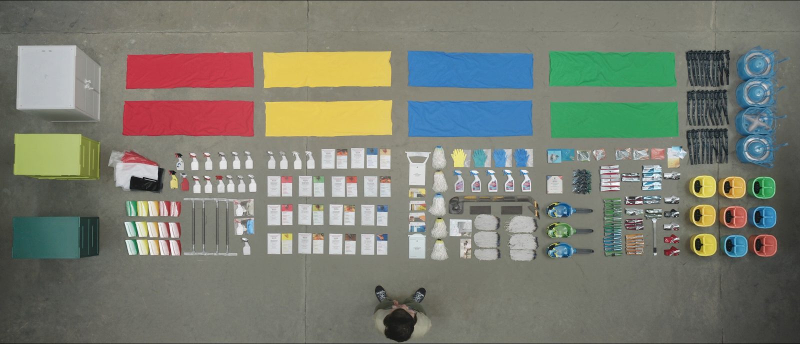 Overhead flat-lay of colour-coded commercial cleaning equipment