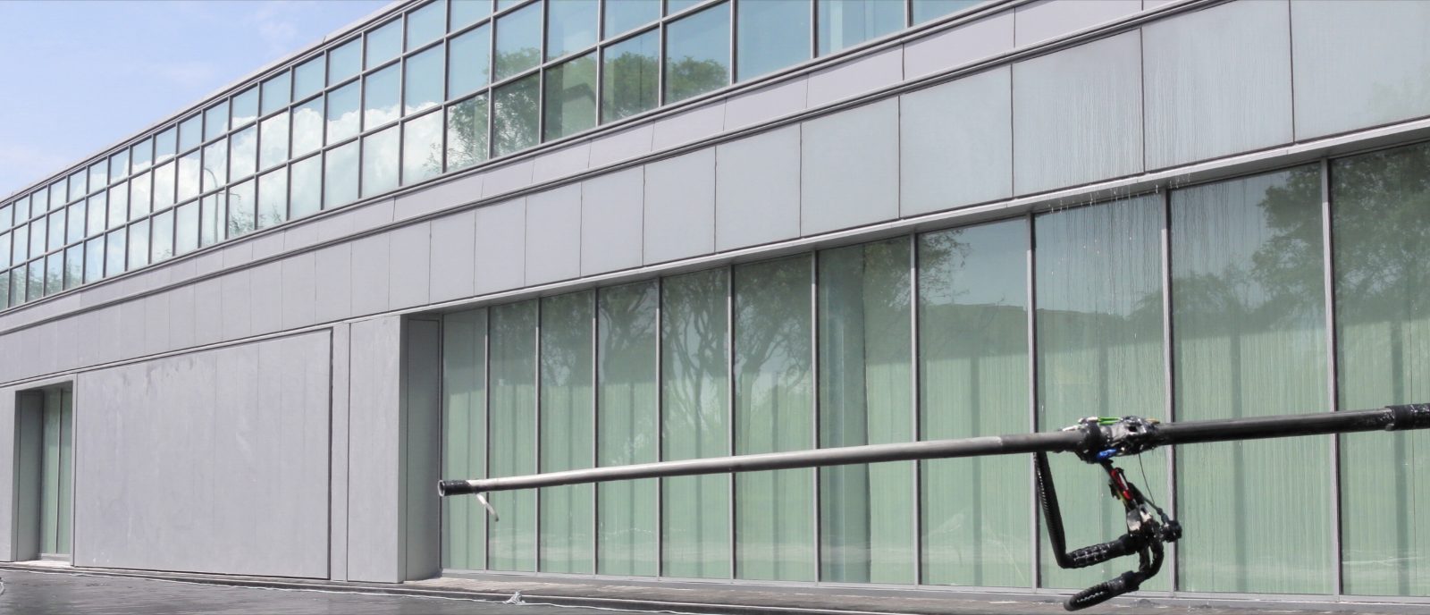 Commercial glass curtain wall cleaned with a water-fed pole